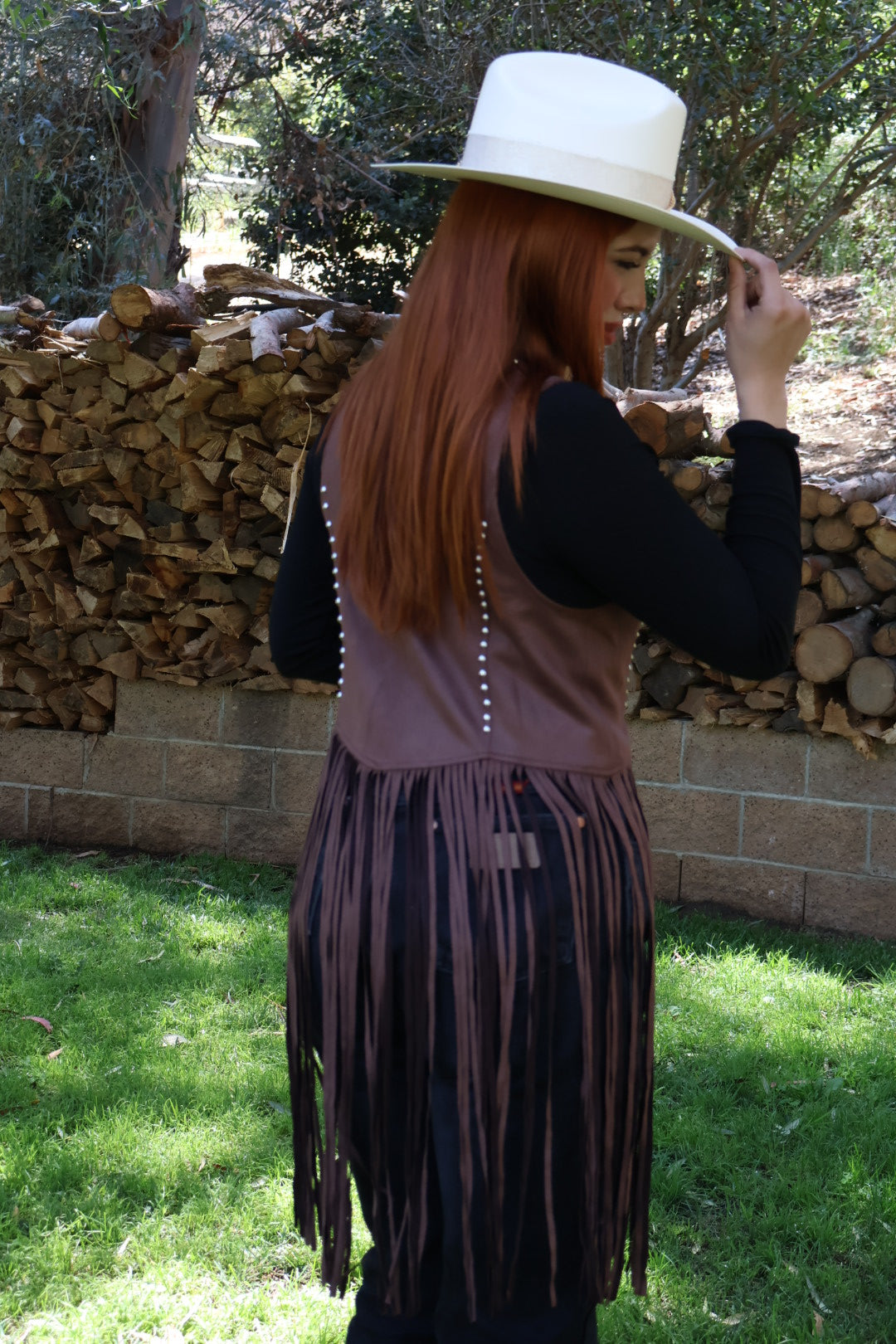 Brown western-style fringed vest with studs